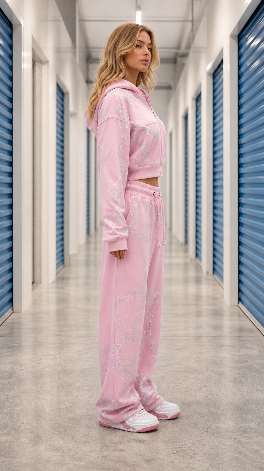 Side angle view of model wearing Light Pink two piece cropped hoodie and wide leg sweats set