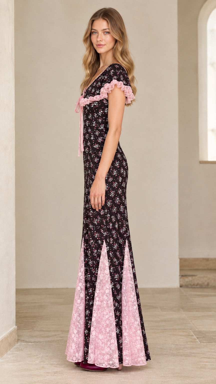 Side profile view of black floral godet maxi dress showing lace trim