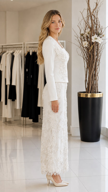 Side profile view of model wearing white long-sleeve top and sequined column skirt
