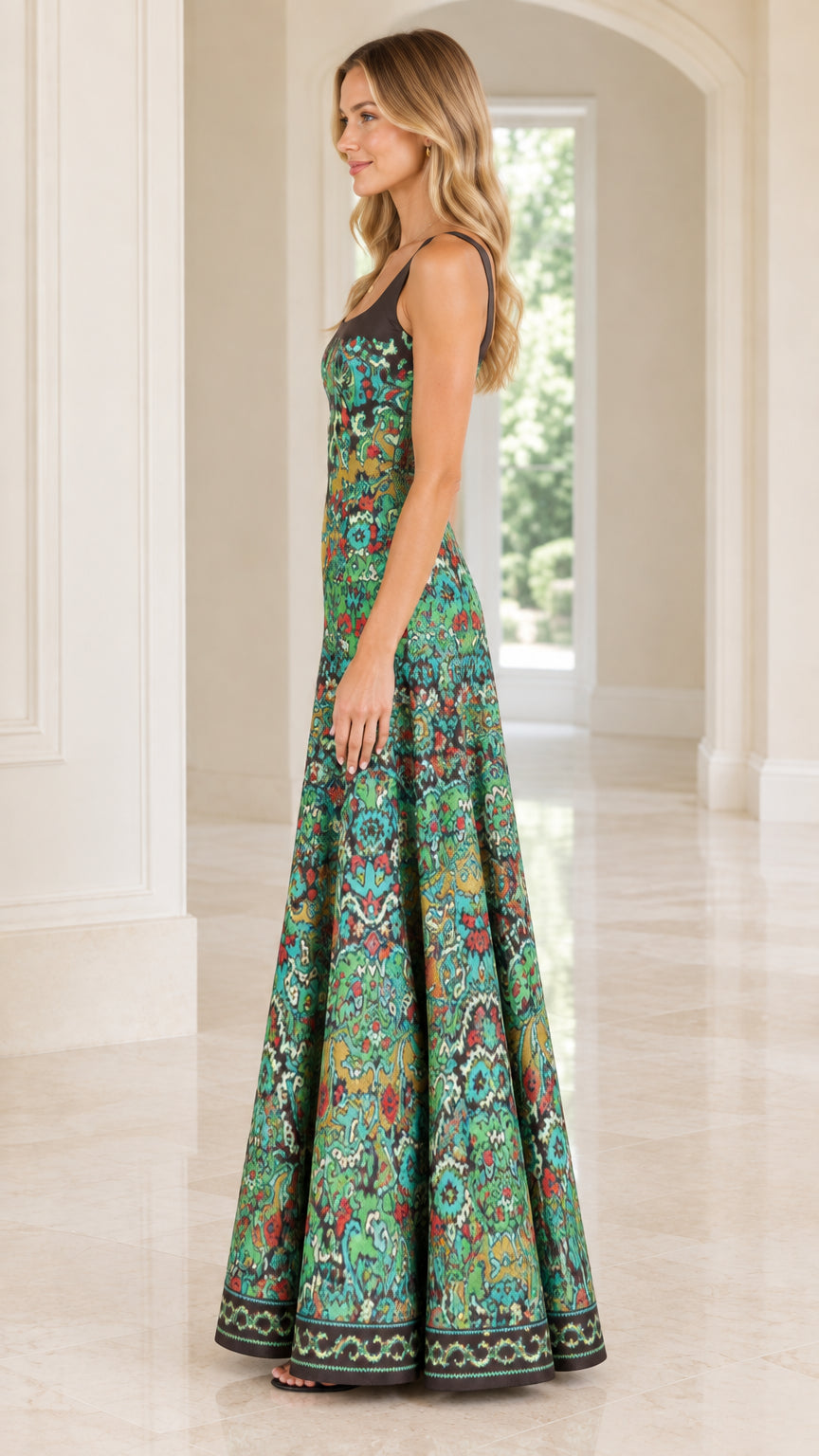 Side profile view of woman wearing teal green vintage print A-line floor length gown