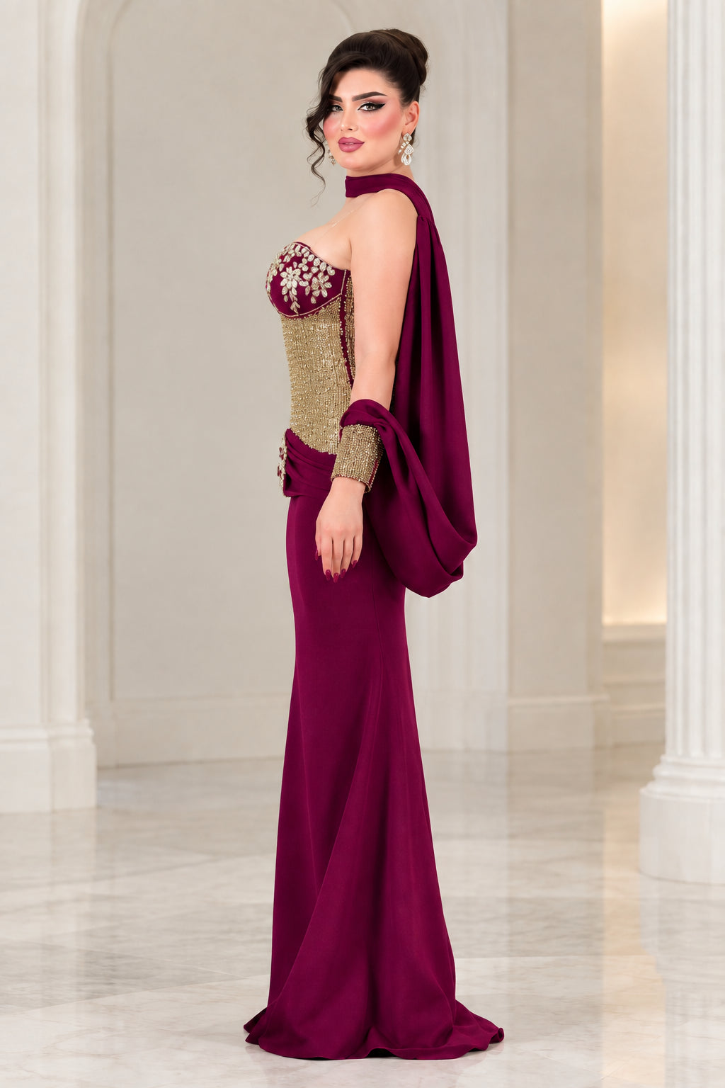 Burgundy evening gown side profile showing structured sequined bodice and flowing cape