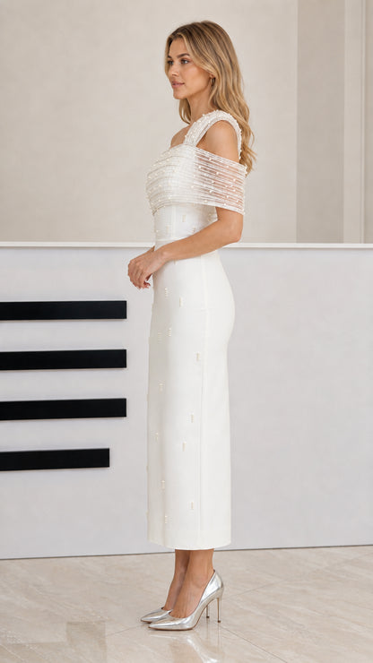 Side profile view of white one-shoulder column midi dress with sheer strap detail
