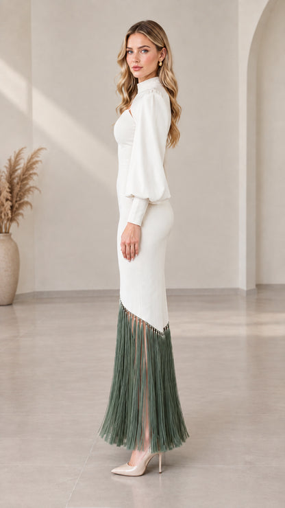 Side view of model wearing white long sleeve cutout evening dress with fringe trim