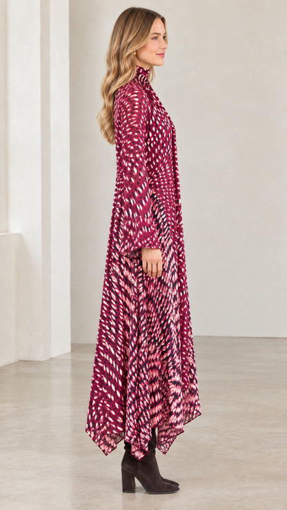 Side view of model showing the flowing silhouette of the magenta tie-neck dress