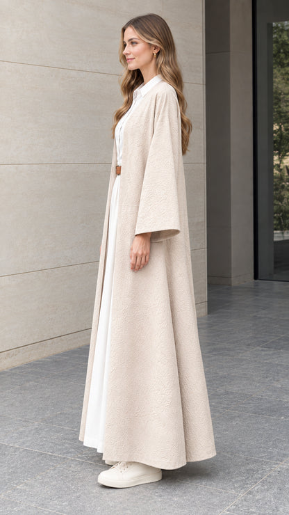 Side profile view of woman modeling beige open-front maxi duster cardigan