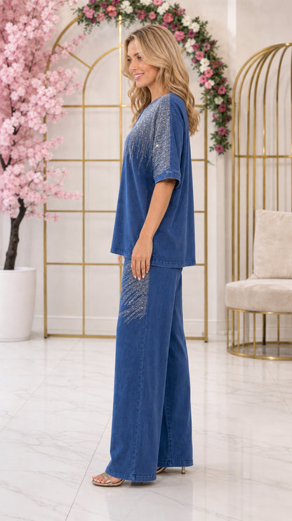 Side profile view of woman wearing denim blue two-piece embellished pant set