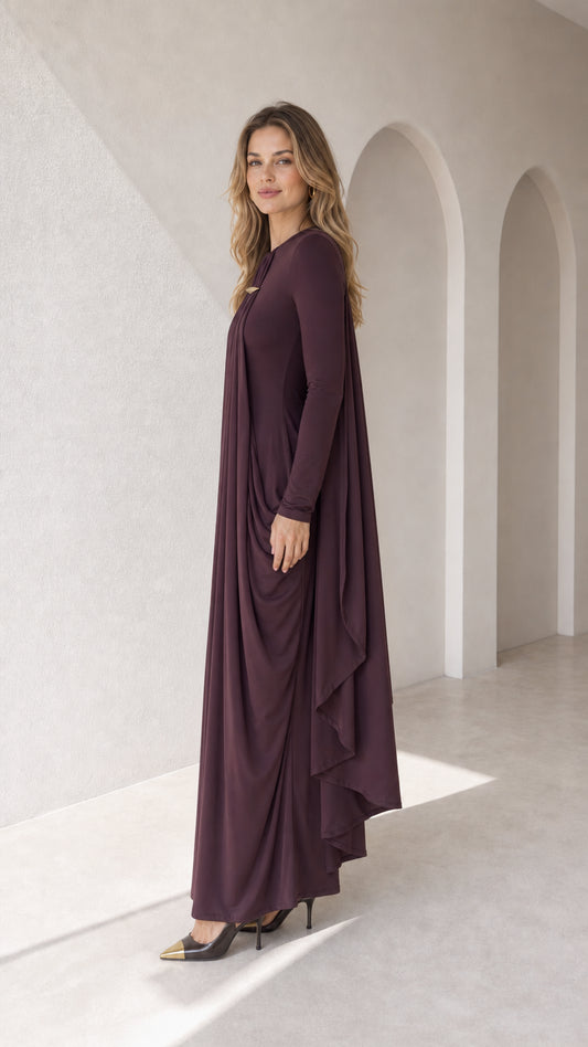 Side angle view of plum long sleeve pleated cape gown showing flowing drape