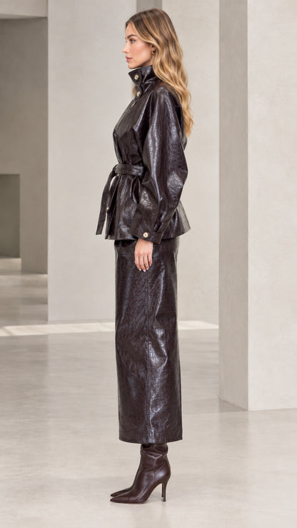 Side profile of woman in Dark Brown croc-embossed faux leather two-piece jacket and skirt set
