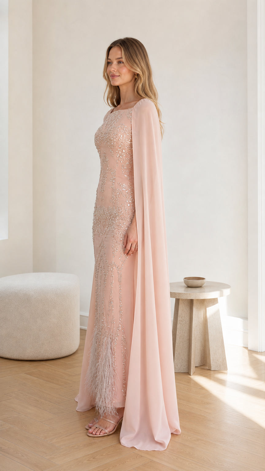 Three-quarter side view of the Blush Pink cape formal dress