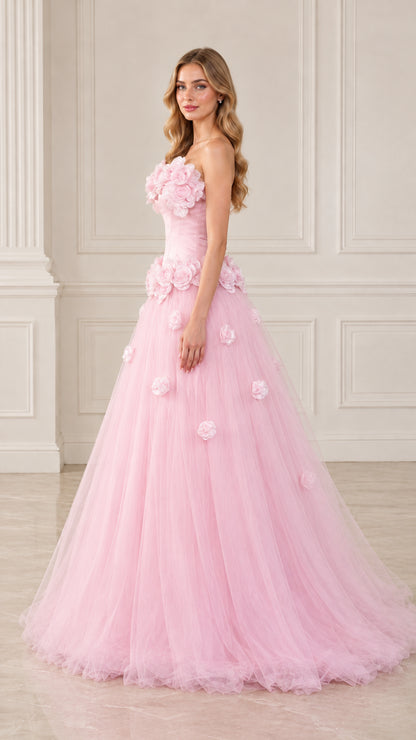 Side angle view of model posing in blush pink floral appliqué tulle evening dress