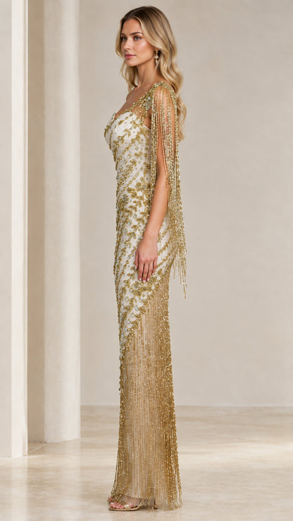 Side profile of model in Ivory Gold one-shoulder embellished gown showing shoulder fringe