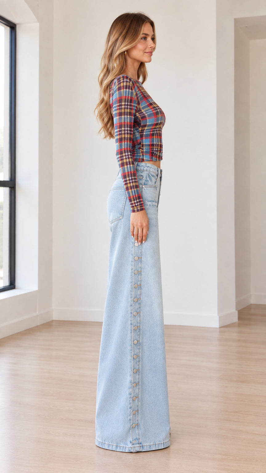 Side full-length view of Blue Plaid long sleeve crop top and light wash wide leg denim