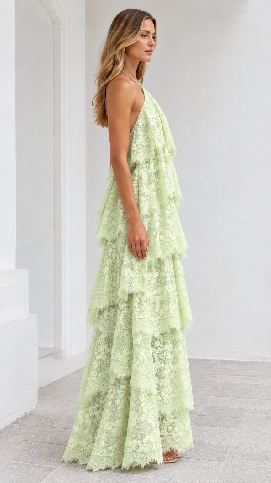 Side view of model posing in Mint Green tiered lace halter dress