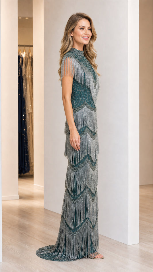 Side angle of model wearing emerald green tiered fringe formal maxi dress