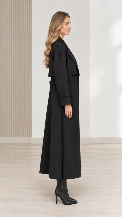 Side view of women's black long trench coat with belt