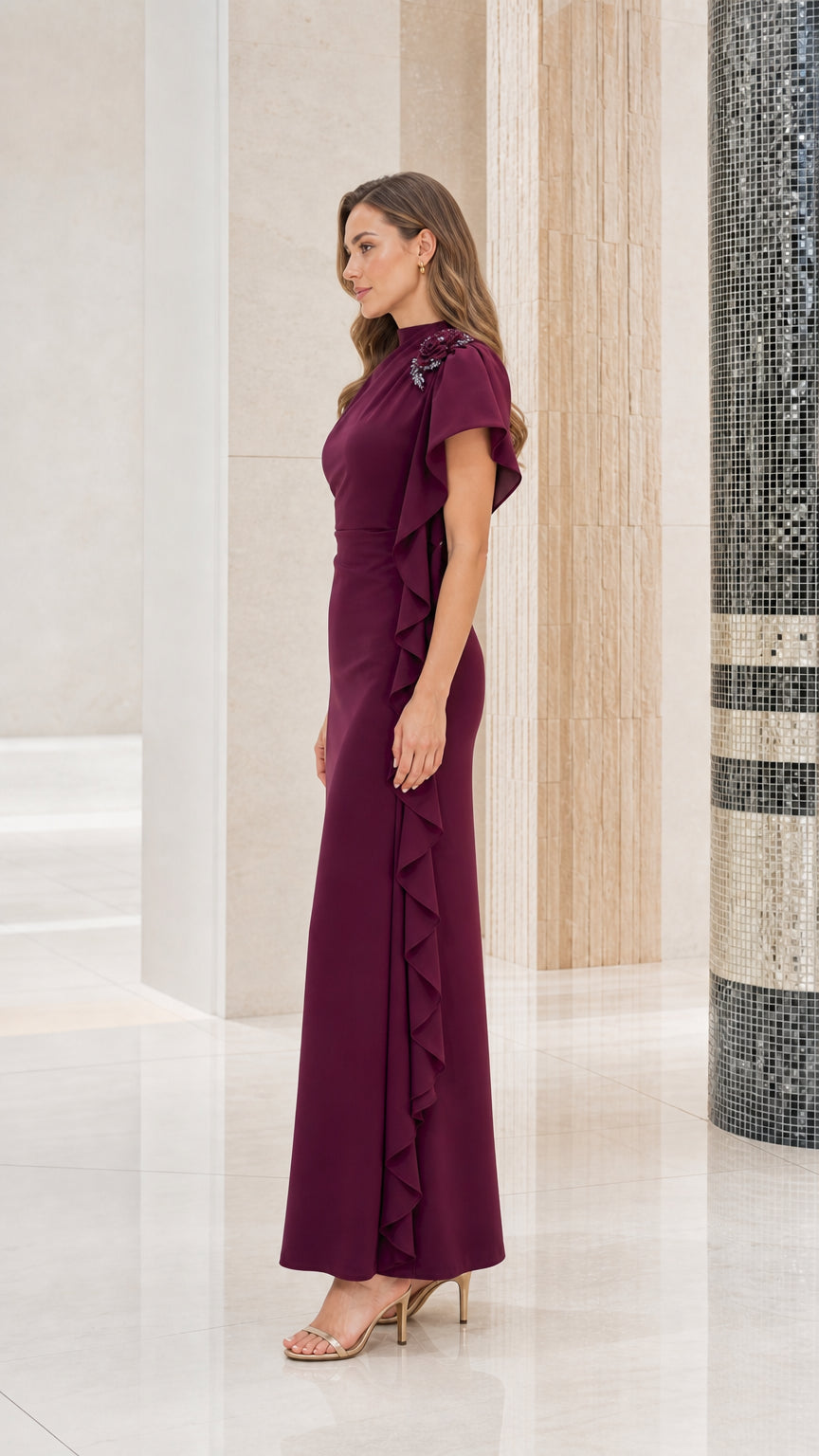 Side profile view of woman modeling the burgundy asymmetrical ruffle evening gown