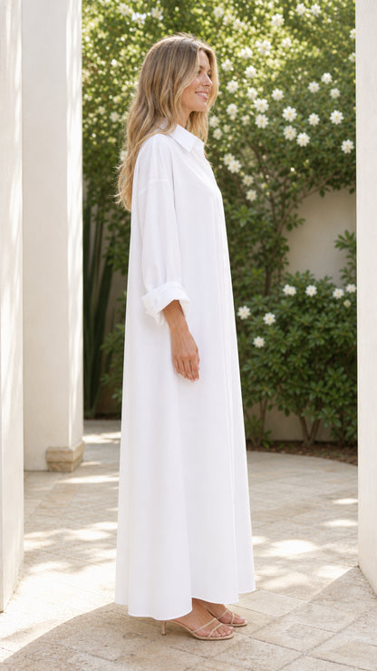 Side profile view of woman wearing white long sleeve maxi shirt dress