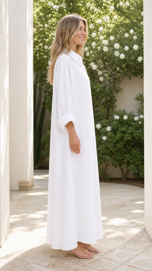 Side profile view of woman wearing white long sleeve maxi shirt dress