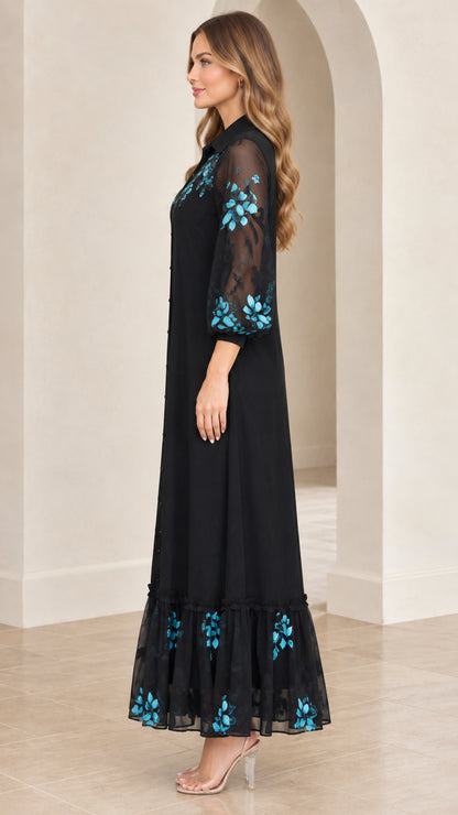 Side angle of model wearing black embroidered button-front maxi shirt dress