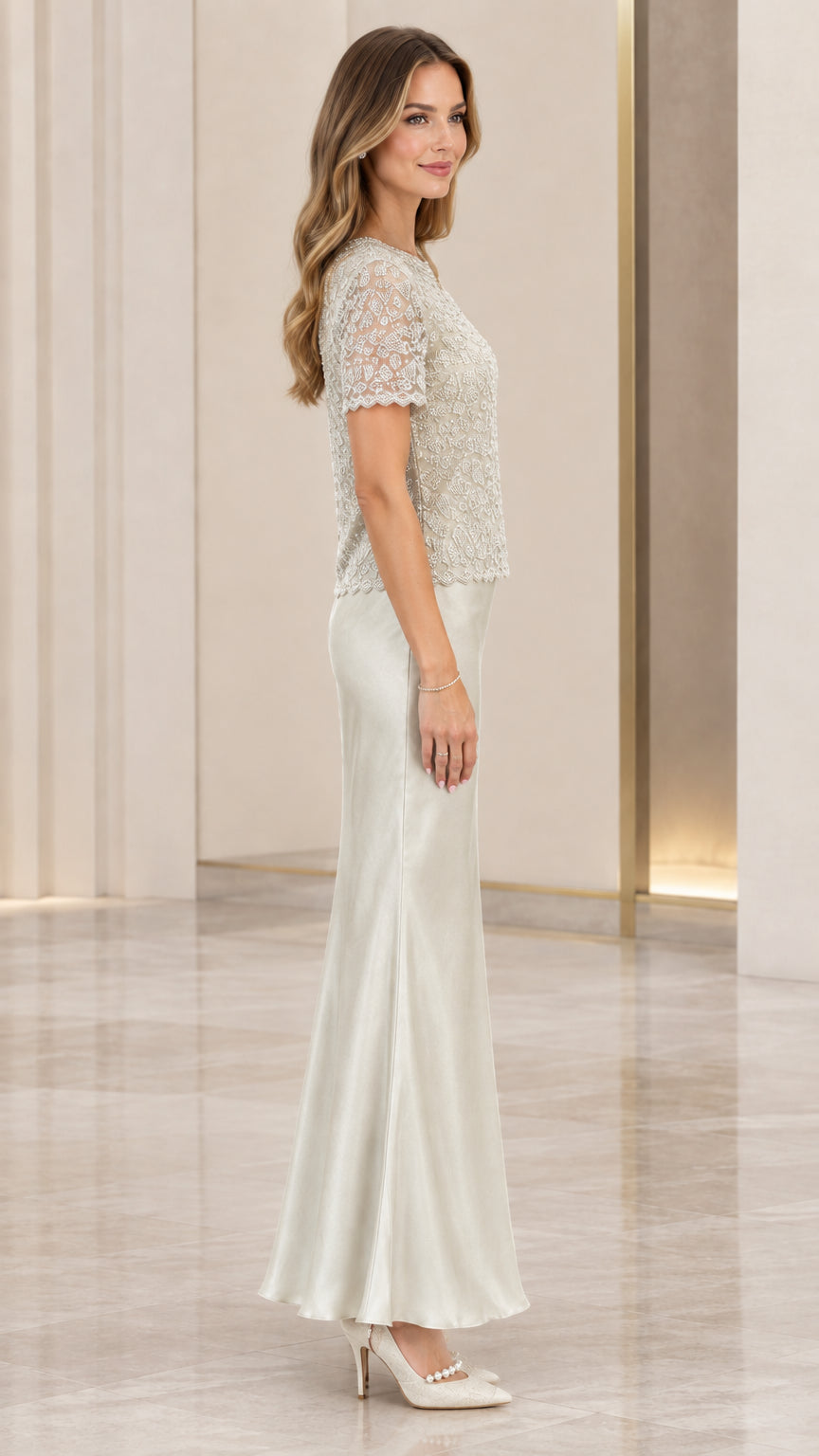 Side profile view of silver beaded bodice and flowing satin skirt evening dress
