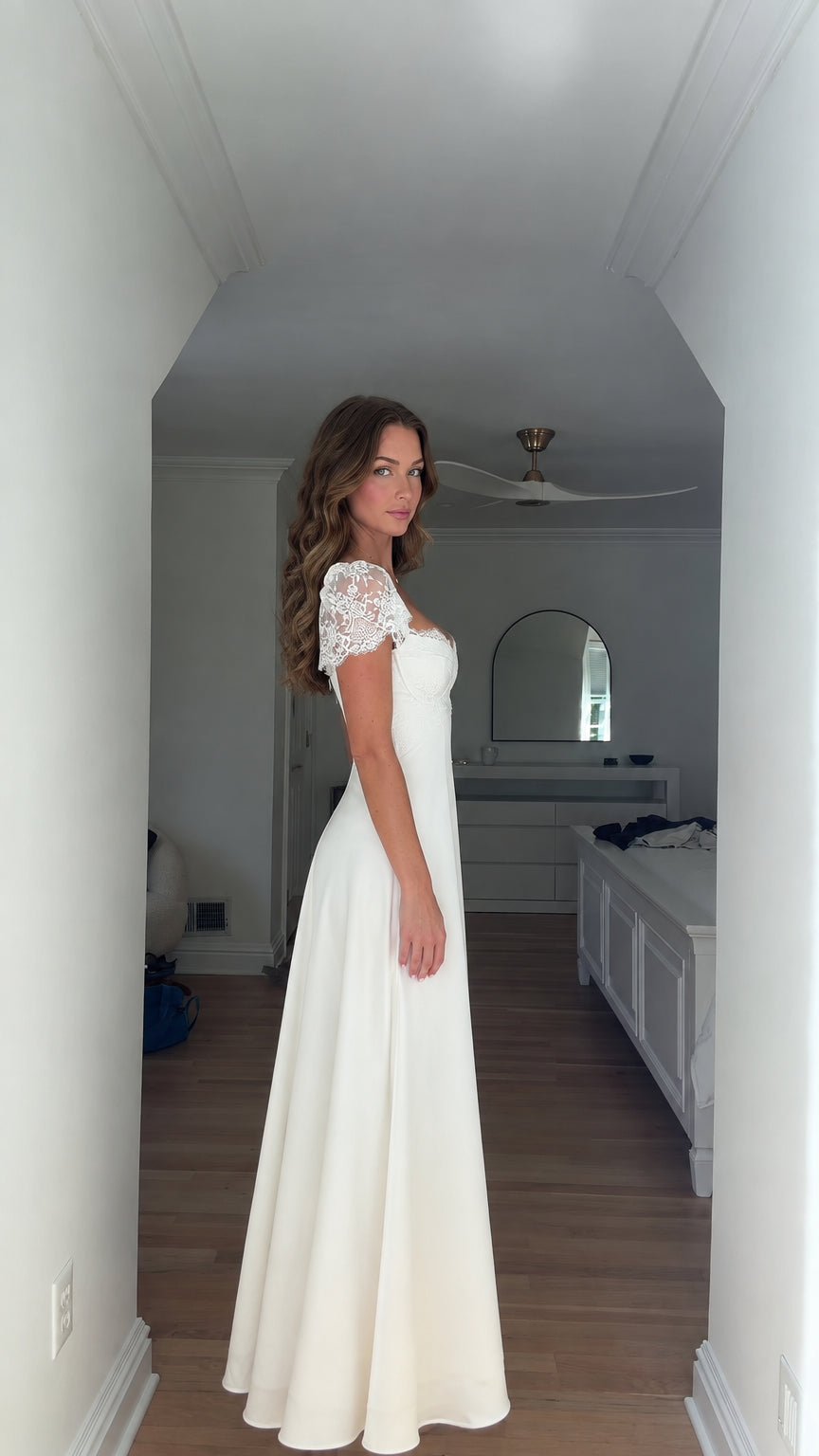 Side angle view of model in white corset A-line maxi gown