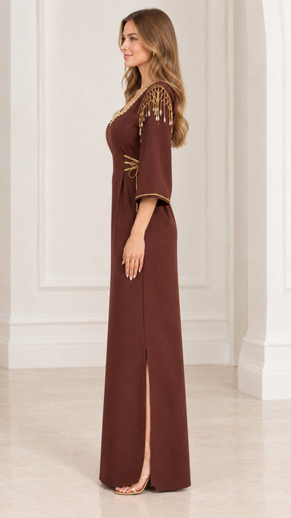 Side profile view of brown embellished maxi dress showing side slit and shoulder details