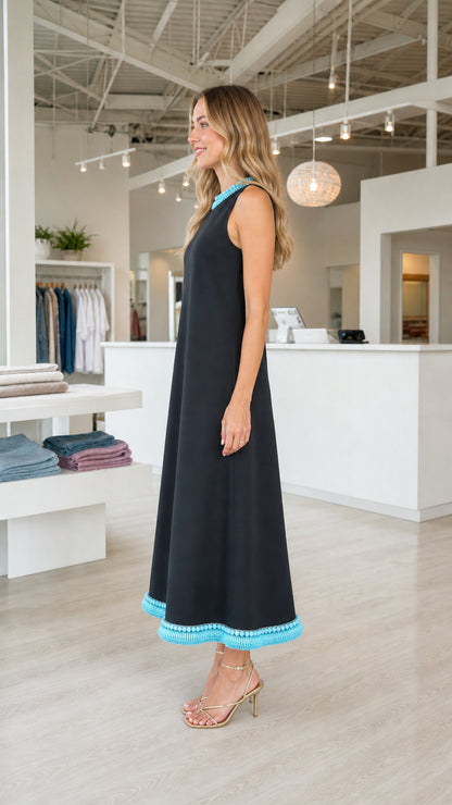 Side view of model wearing black sleeveless A-line midi dress