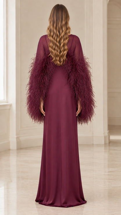 Back view of floor length burgundy evening gown with feather details