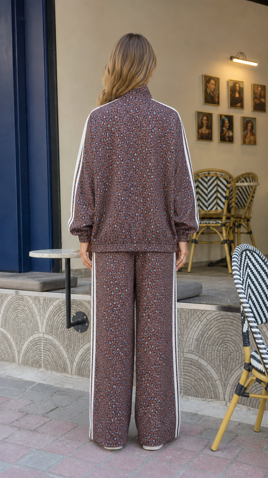 Back view of woman wearing brown leopard print track jacket and wide leg trousers