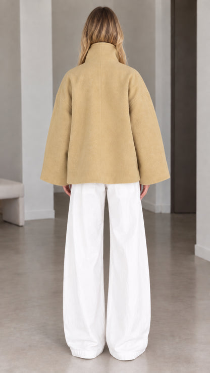 Back view of model wearing relaxed camel batwing sleeve short jacket