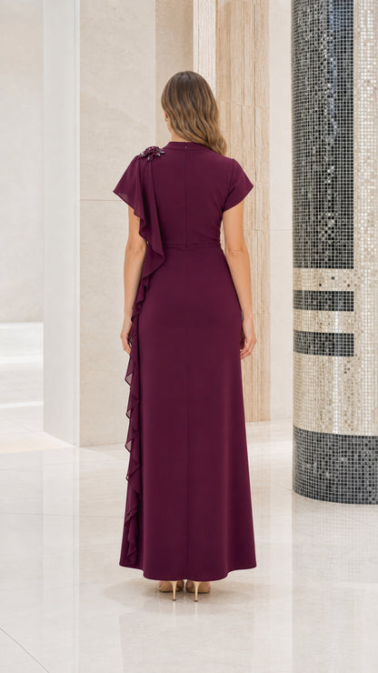 Back view of woman wearing burgundy mock neck formal gown showing smooth back fit