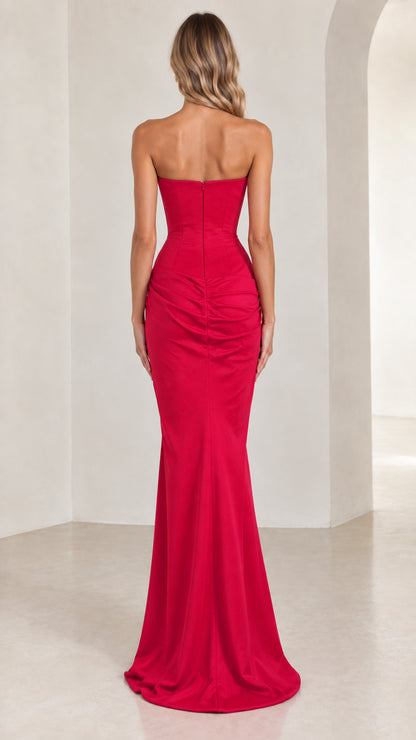 Back view of model in fitted red strapless formal dress with zipper closure