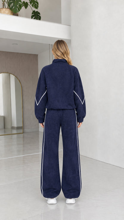Back view of women's navy blue textured fleece tracksuit set