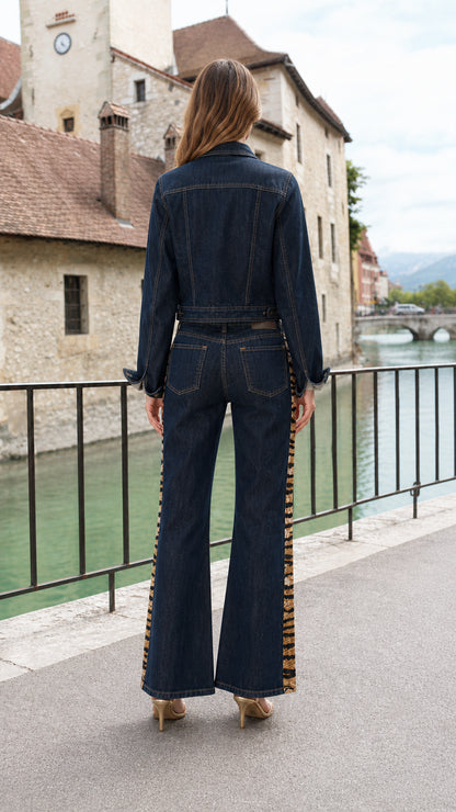 Back view of model wearing Dark Blue denim two piece jacket and flare pants set