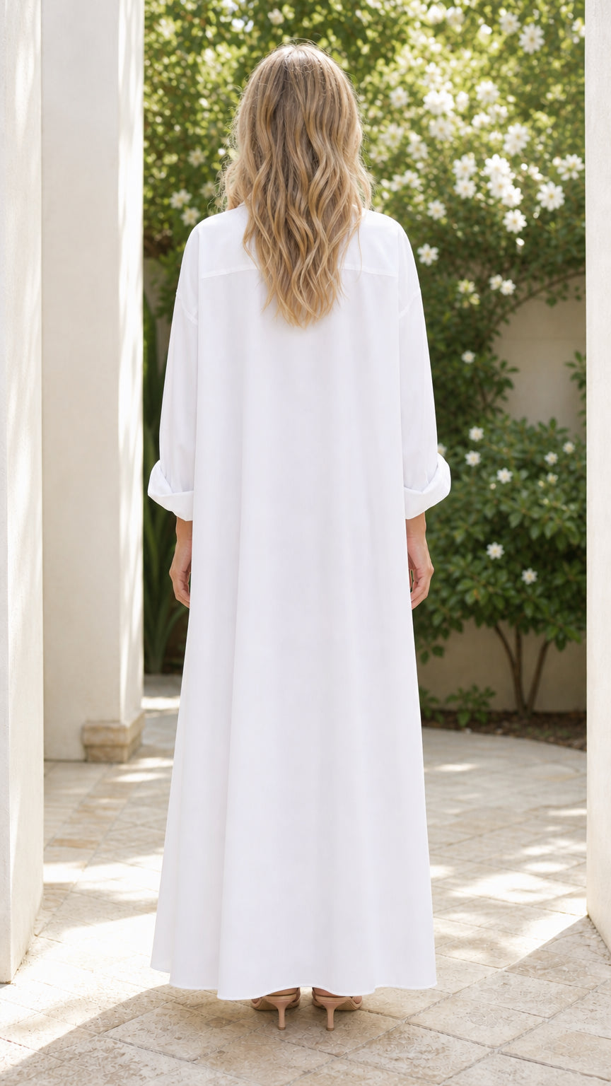 Back view of woman wearing white button down maxi shirt dress