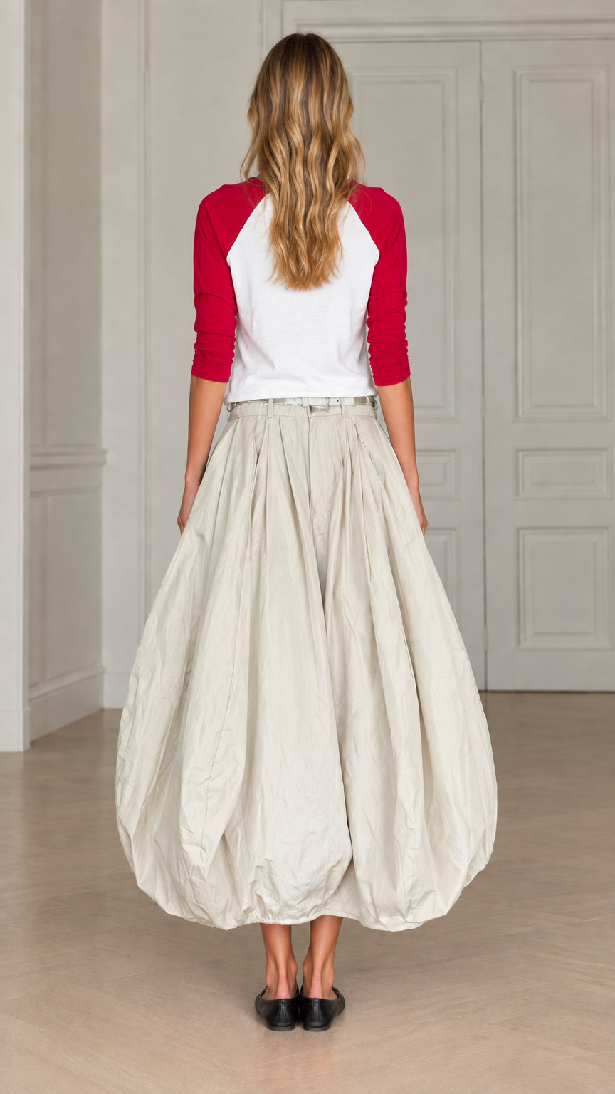Back view of model wearing cream bubble maxi skirt with red and white raglan top