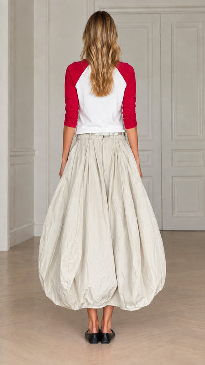 Back view of model wearing cream bubble maxi skirt with red and white raglan top