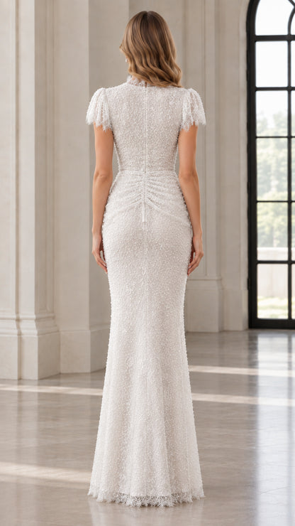 Back view of model in white sequin evening gown with ruched detailing and zip closure