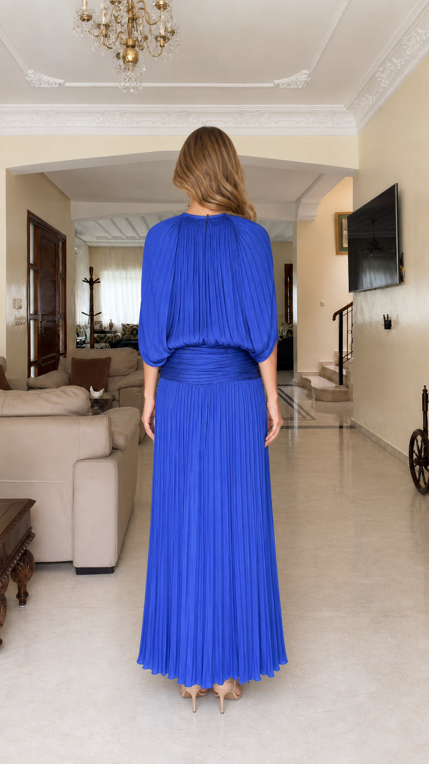 Back view of woman wearing Royal Blue pleated evening maxi gown