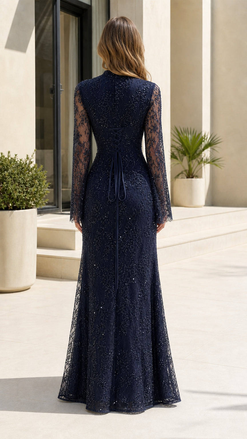 Back view of navy blue lace evening gown showing corset lace-up tie detail