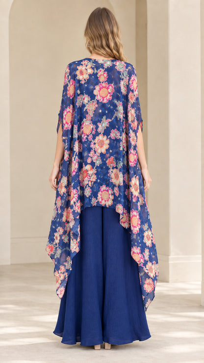 Back view of royal blue sweeping floral duster cape and matching palazzo pants