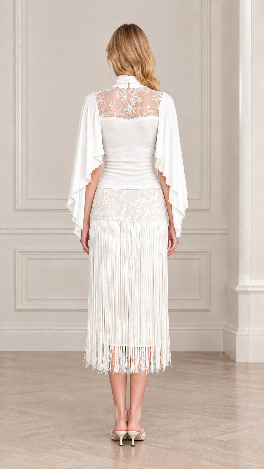 Back view of model in white illusion lace back fringe midi dress