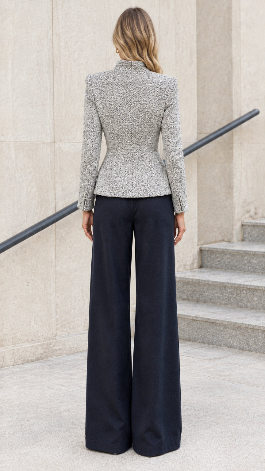 Back view of light grey fitted tweed jacket highlighting sculpted waist