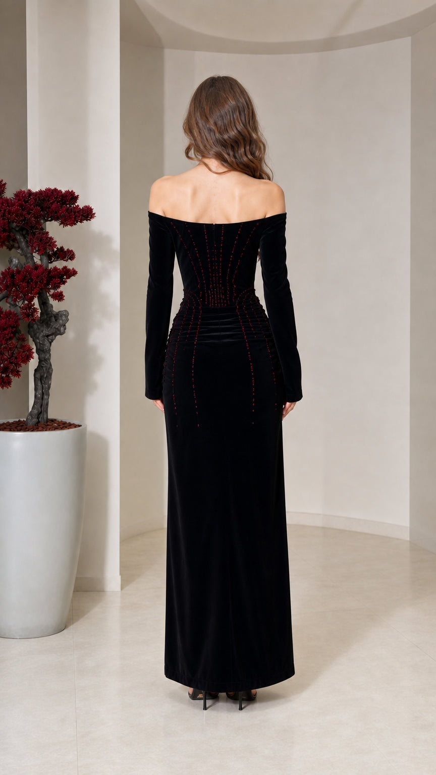 Back view of model in black long-sleeve velvet column gown
