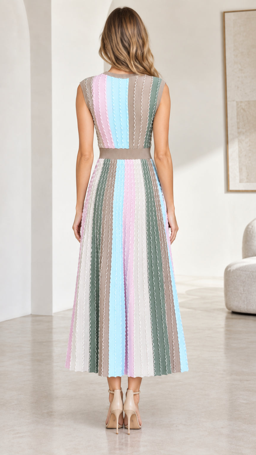 Back view of model wearing sleeveless striped A-line knit dress