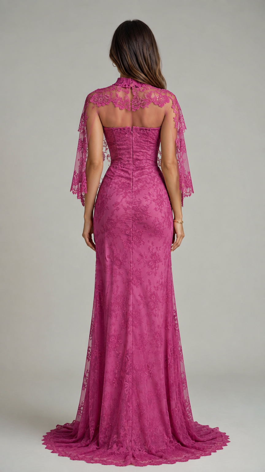 Back view of magenta lace formal gown with sheer lace capelet covering shoulders