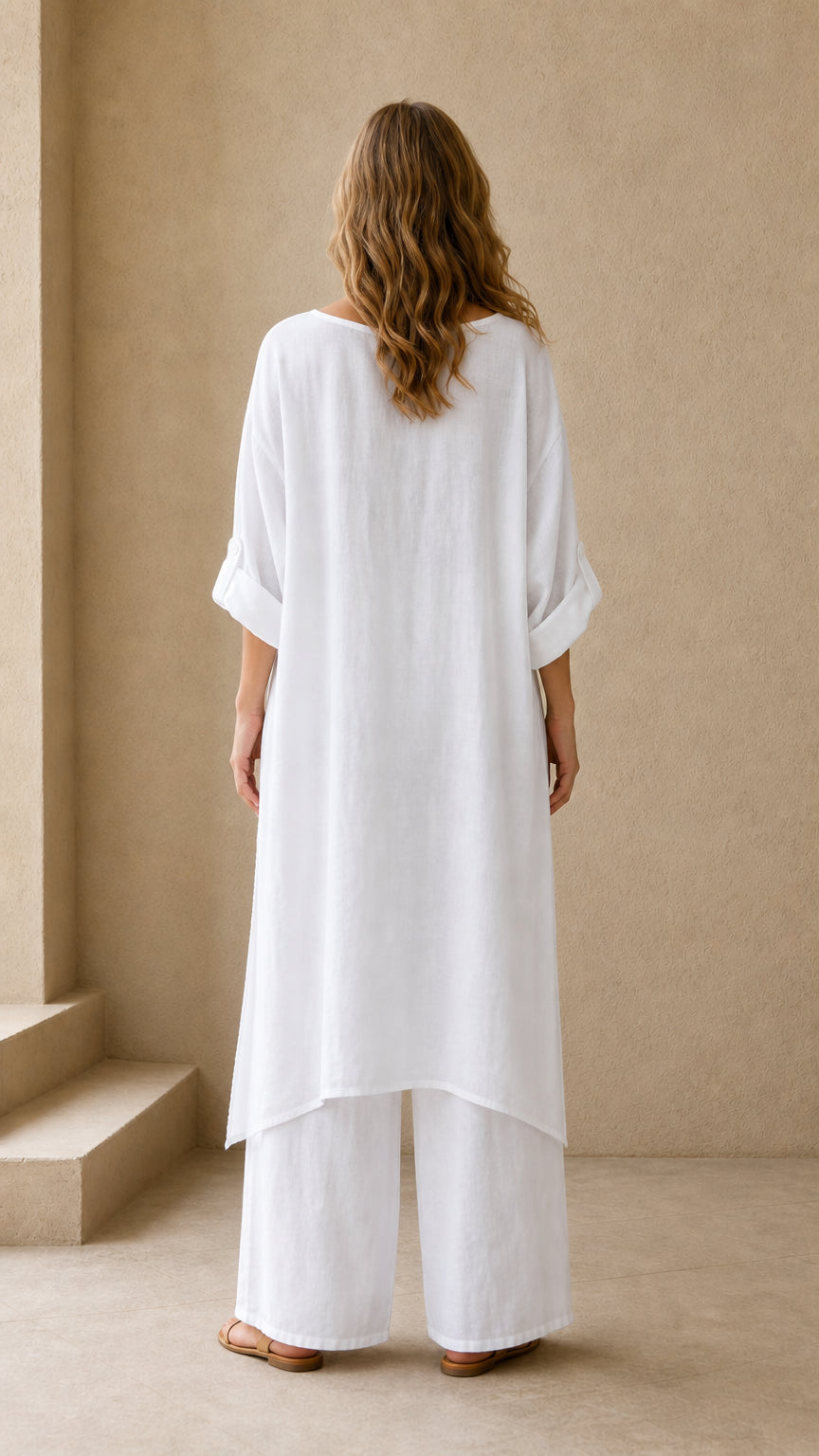 Back view of white relaxed fit longline tunic and wide leg trousers set