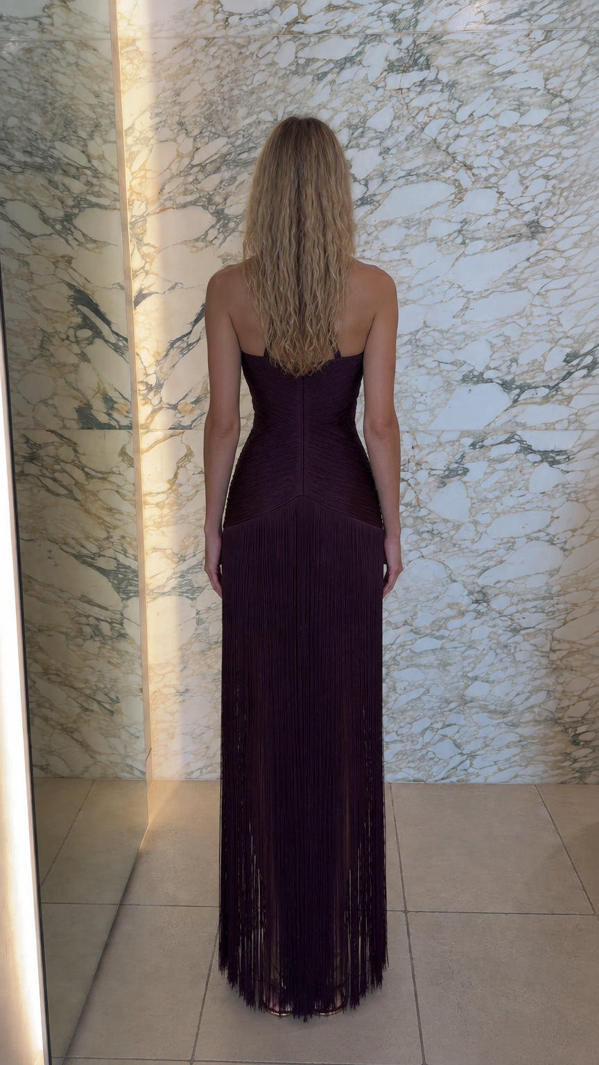Back view of model showing open back detail of burgundy fringe maxi dress