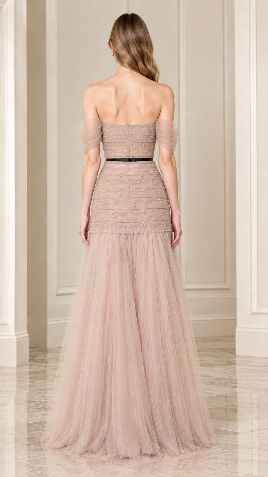 Back view of champagne off-the-shoulder evening gown showing tulle skirt and waist belt