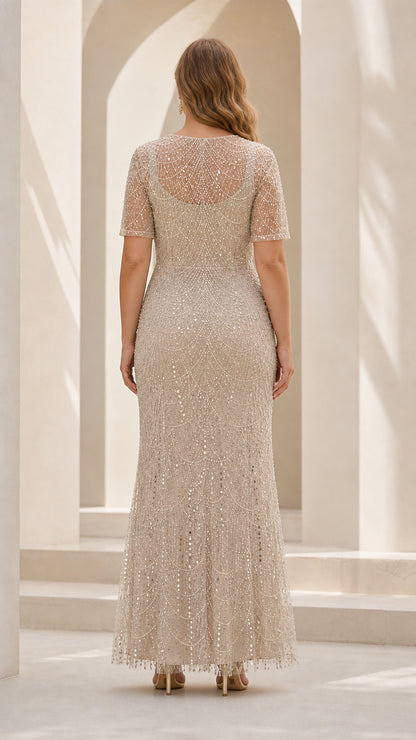 Back view of woman in Champagne sequin and pearl beaded evening gown